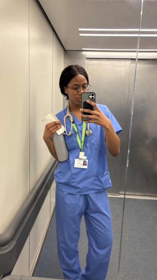 Christina in NHS scrubs with a stethoscope